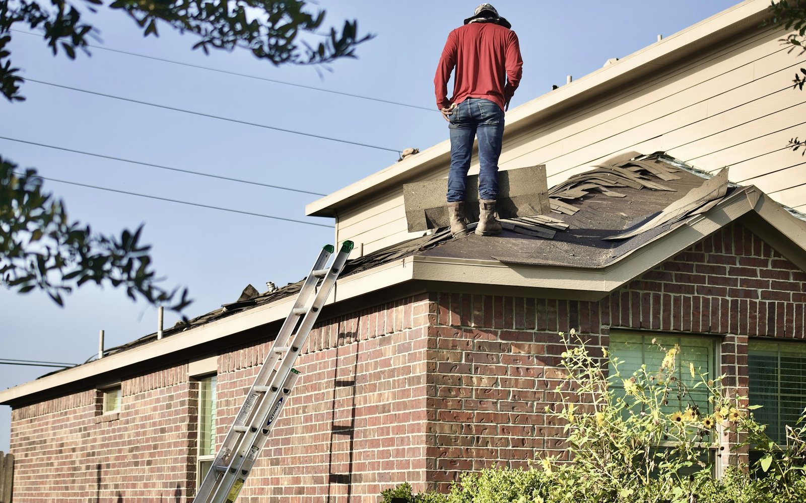 Roofer working on a brick house